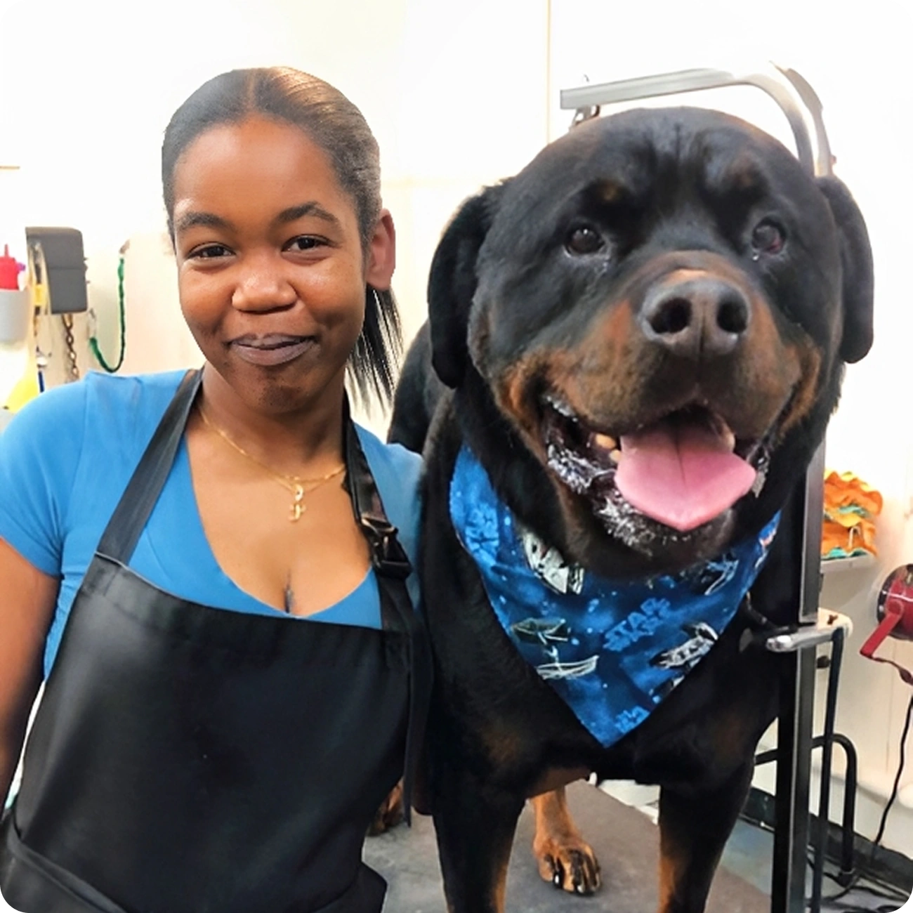 Woman with dog wearing blue bandana.
